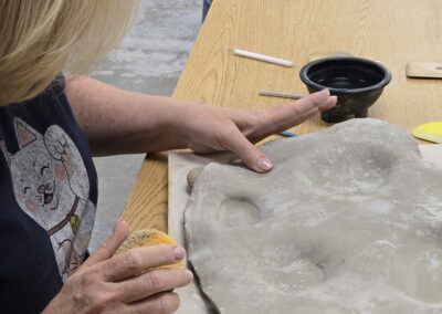 HUB Pottery Student Working on Board